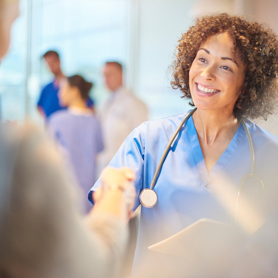 A medical professional from an outplacement firm shaking hands with an individual
